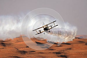 Wing walkers on a bi-plane over the desert