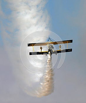 Wing walkers standing on a bi-plane over the desert