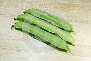 Winged Bean or Princess Bean on wooden chopping block