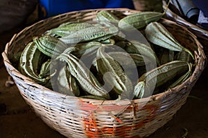 Winged beans in the wicker basket in the Indian market in Mauritius.