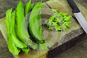 Winged beans on wooden background