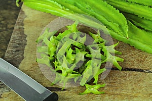 Winged beans on wooden background