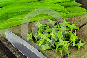 Winged beans on wooden background