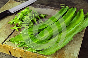 Winged beans on wooden background