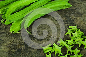 Winged beans on wooden background