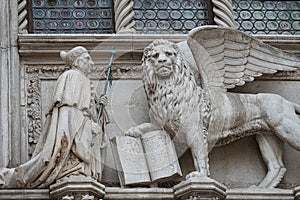 Winged lion with a Bible and a priest at Basilica San Marco in Venice, Italy, summer time, details, closeup