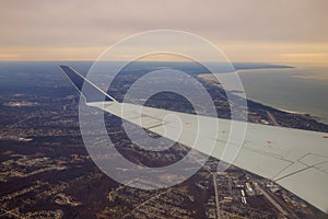 Winglet in graduated dark blue sky with a view of big city below in Cleveland Ohio