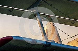 wings of an old airplane against a blue sky