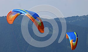 The wings of two paragliders.