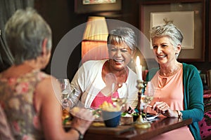 Wining, dining and reminiscing. Cropped shot of a group of senior female friends enjoying a lunch date.