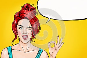 Winking girl is showing OK sign with speech bubble. Pop Art girl. Party invitation. Birthday greeting card. Hollywood movie star.