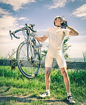 Winner of a Bike Race kisses the Trophy