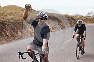 Winner, celebrating and winning cyclist cycling with his friend and racing outdoors in nature. Victory, joy and happy