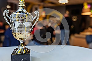 Winner or champion gold trophy cup with abstract dark blurred background. Victory first place of competition. Winning or