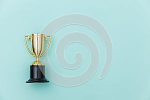Winner or champion gold trophy cup isolated on blue pastel colorful background