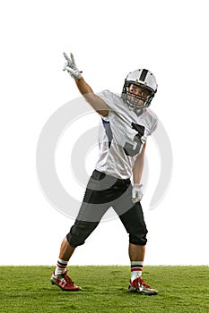 Winner, champion. Portrait of American football player training isolated on white studio background with green grass