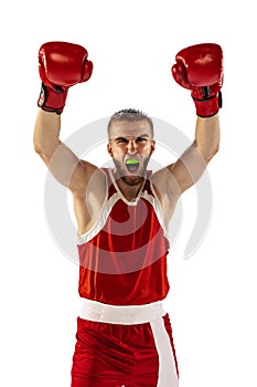 Winner emotions. Male boxer in red uniform and boxing gloves training isolated on white background. Strength, attack and