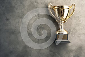 Winner gold trophy cup on concrete stone grey background, top view