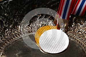 Winner medal with fabric neck holder ribbon.