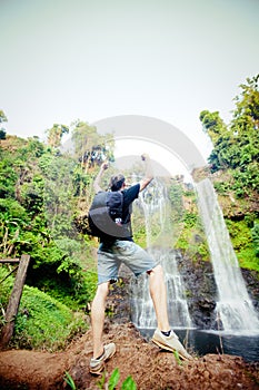 Winner near waterfall. Active life concept