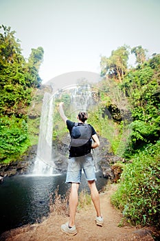 Winner near waterfall. Active life concept