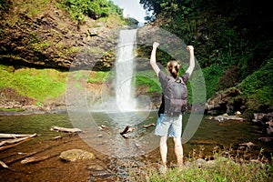 Winner near waterfall. Active life concept