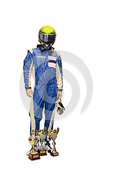 Winner race driver in blue white motorsport overall gloves integral safety crash helmet and golden cups isolated on white