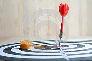 Winner Red dart arrow hit the center target of dartboard and yellow arrow loser metaphor marketing competition concept