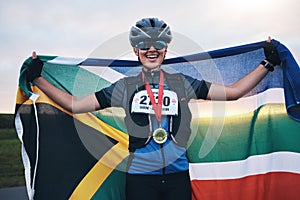 Winner sports, happy woman from South Africa with flag and gold medal winning, outdoor cycling race or triathlon