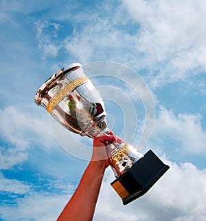 The winner takes it all. Champion winner trophy cup on sky background.