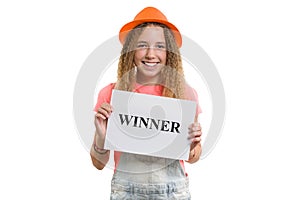 Winner text message written on white paper in hands pretty young teen girl, smiling girl in hat on isolated white background