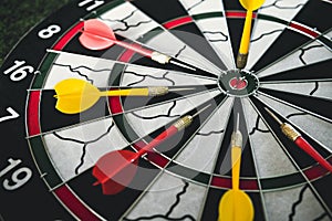 Winner yellow dart arrow hit center target of dartboard and other arrow loser metaphor marketing competition concept, on