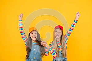 Winners reaching their goal. Excited little children making winner gestures on yellow background. Cute small winners