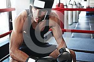 Winning is all a matter of mindset. a young man training in a boxing ring.
