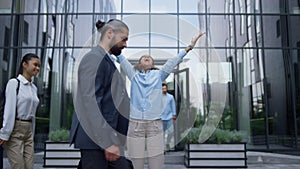 Winning business lady screaming raising hands up in crowded office city center.