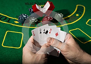 Winning combination in poker game. Cards and chips on a green cloth