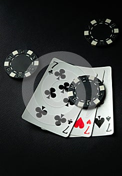 Winning combination of three of a kind or set of cards on a black poker table in a club or casino. Successful poker game concept