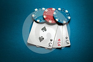 A winning combination of three of a kind or set of cards on a poker table in a club. Successful poker game concept with playing