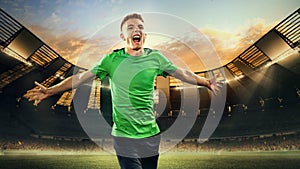 Winning emotions. Happy young man, football player running with happy emotions on 3D open air football stadium with