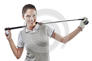 Winning is just par for the course. Studio shot of a young golfer holding a golf club behind her back isolated on white.