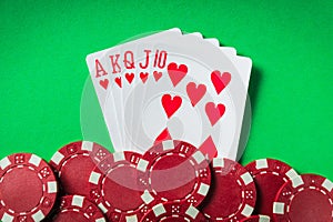 A winning poker combination is Royal Flush. Chips and cards on the green table in the poker club. Luck or Fortune