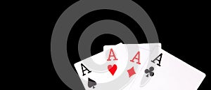 A winning poker hand of four aces playing cards suits on black background