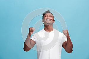 Winning success afro-american man happy ecstatic celebrating being a winner. Dynamic energetic image of male model