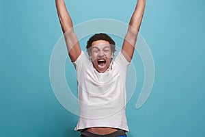 Winning success man happy ecstatic celebrating being a winner. Dynamic energetic image of male model