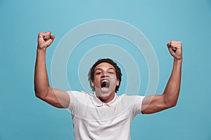 Winning success man happy ecstatic celebrating being a winner. Dynamic energetic image of male model