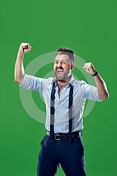 Winning success man happy ecstatic celebrating being a winner. Dynamic energetic image of male model