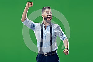 Winning success man happy ecstatic celebrating being a winner. Dynamic energetic image of male model