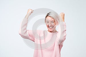 Winning success woman happy ecstatic celebrating being a winner. Dynamic energetic emotion of caucasian female model