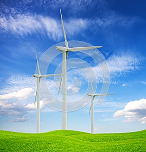 Wint turbines oh green hill and blue sky. Alternative source of energy