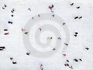 Winter active sports. Top view motion background of parents and kids play ice skating.